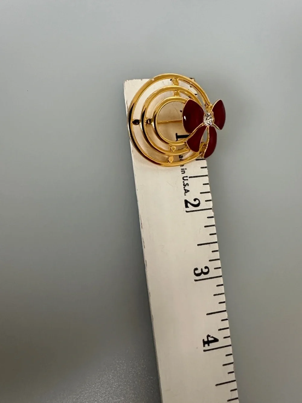 Gold-Tone Brooch with Red Enamel Bow and Crystal Accent